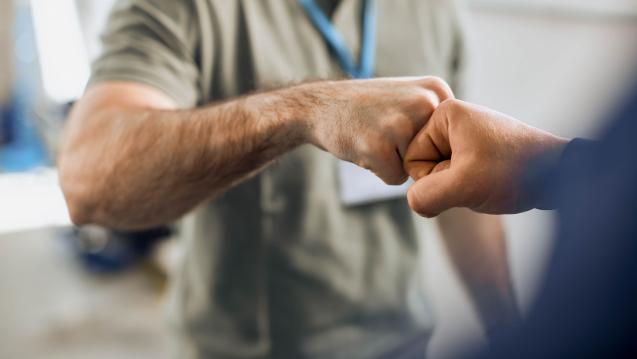 A fist bump shared between two people